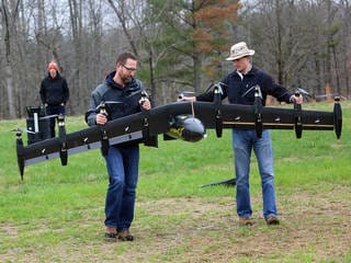 Engineers David North (L) and Bill Fredericks (R) carry the Greased Lightning before one of its flight tests. / NASA Langley/David C. Bowman